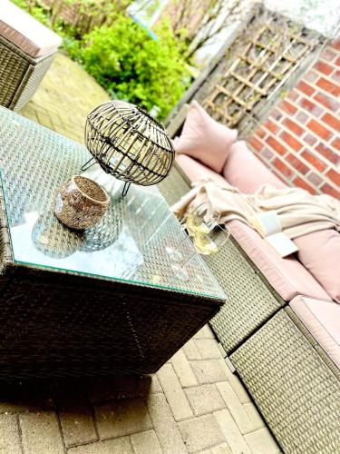 a glass table with a hat on top of it at Seeliebe, 300 Meter zum Wasser, mit Terrasse und Garten in Lembruch