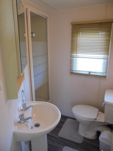 a bathroom with a sink and a toilet at 8 Berth on Sealands Everglade III in Ingoldmells