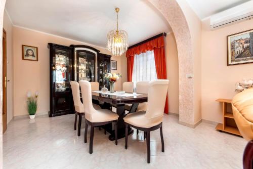 a dining room with a table and chairs at Apartments Divna in Rovinj