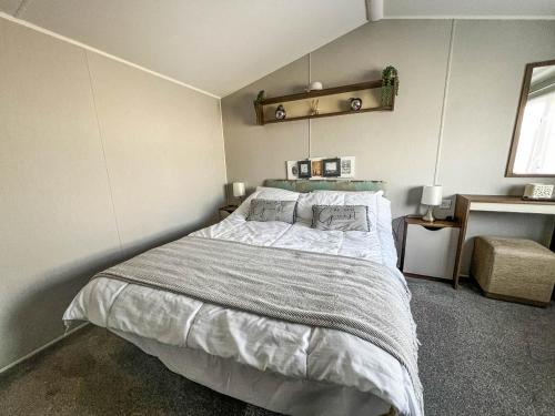 a bedroom with a large bed in a room at Luxury Caravan With Decking And Wifi At Haven Golden Sands Ref 63069rc in Mablethorpe