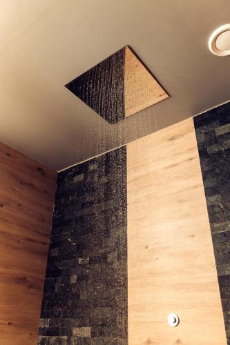 a room with a ceiling with a stone wall at Verhovel Hotel in Verkhovyna