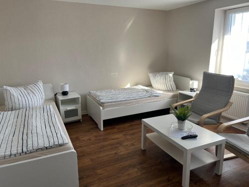 a living room with a bed and a couch and a table at ROTH´s Monteurs- und Ferienapartments in Dessau