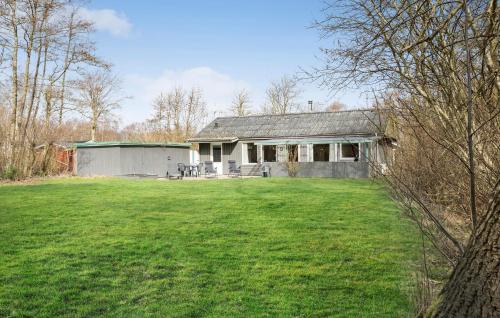 a house with a large yard in front of it at Four-Bedroom Holiday Home In Hemmet in Hemmet
