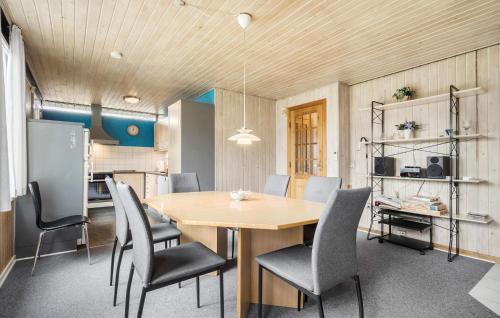 a kitchen and dining room with a table and chairs at Four-Bedroom Holiday Home In Hemmet in Hemmet