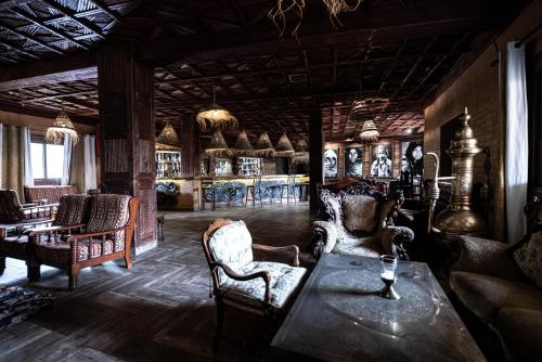 a room with chairs and a table in a room at Kasbah Hotel Xaluca Arfoud in Erfoud