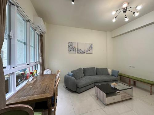 a living room with a couch and a table at Ming House in Taitung City