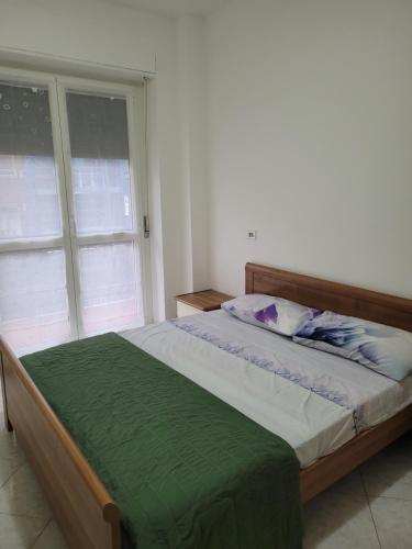 a bed in a bedroom with a large window at FAMILY in San Giuliano Milanese