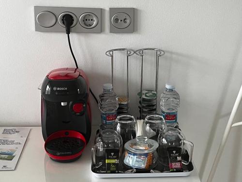 a kitchen counter with a toaster and bottles of water at Casa Iparra Txiki Berri in Irún