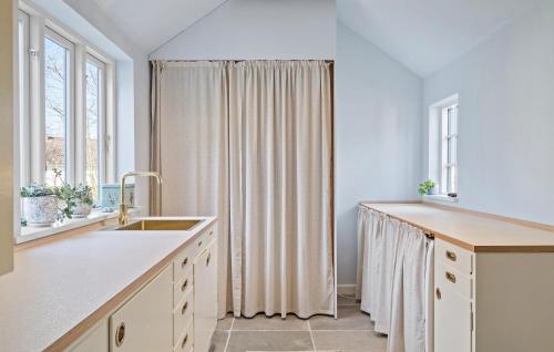 a kitchen with a sink and a shower curtain at 3 Bedroom Amazing Home In Sams in Kolby Kås