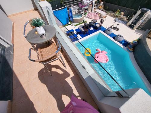 an overhead view of a swimming pool with a table and chair at AL "Villa Por Do Sol" Sunset Olhão in Olhão