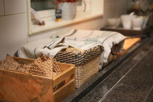 a room with a bed and baskets on a counter at Lannalodge in Vintrosa