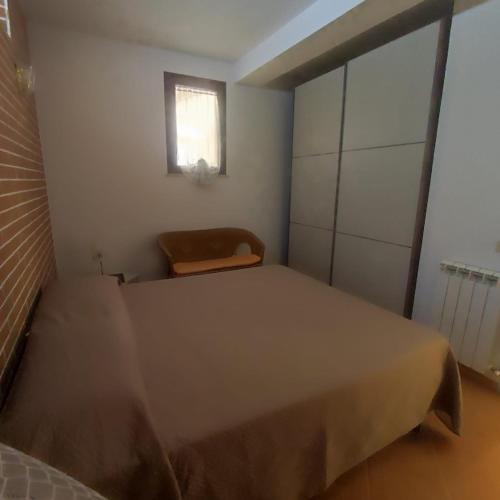 a small bedroom with a bed and a window at alloggio in Palermo
