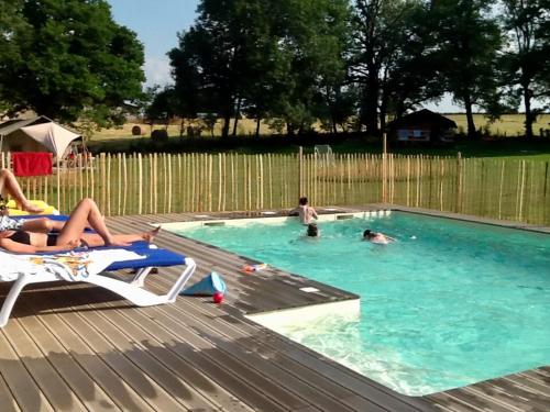 a group of people in a swimming pool at Les Savonniers in Beauregard