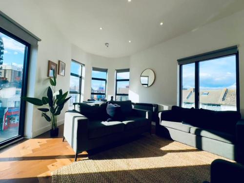 a living room with two couches and windows at Amazing 2 Bedrooms I Brighton station I Sleep 6 in Brighton & Hove