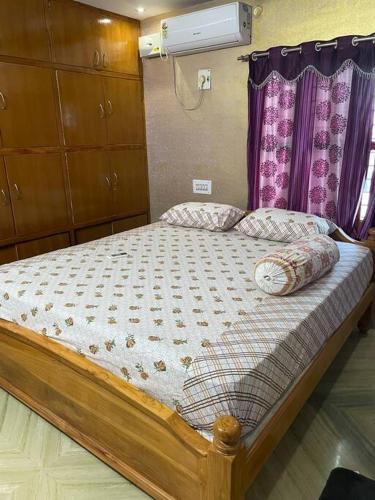 a bedroom with a large bed with at Om Sai Nilayam Guest house in Tirupati