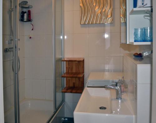 a bathroom with a shower and a sink and a shower at Inselliebe in Groß Zicker