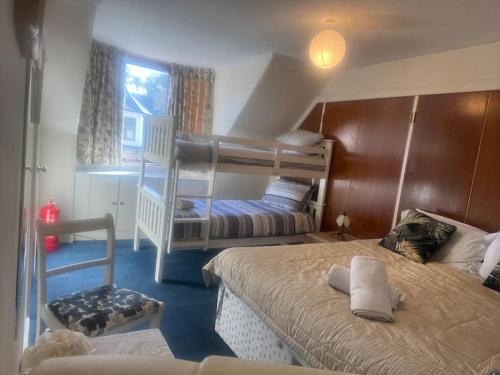 a bedroom with two bunk beds and a staircase at Central 1st Class in Quiet Location in Galashiels