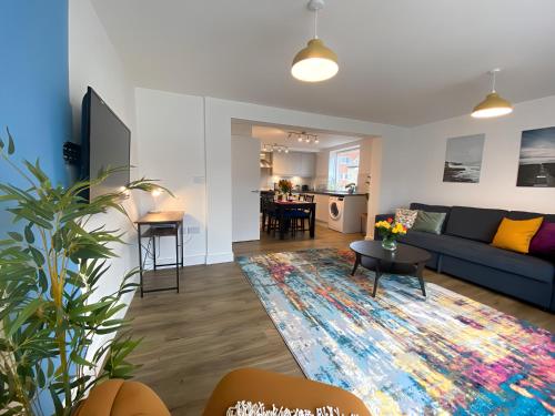 a living room with a couch and a table at Cambridge Stays Riverside 2BR Flat-Walk to Centre-Parking-Balcony in Cambridge