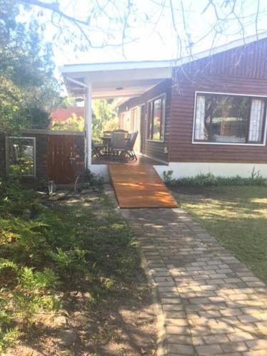 a house with a walkway leading to a patio at Lazy Days in Natureʼs Valley