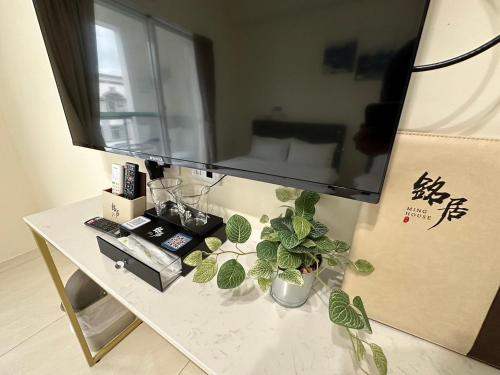 a table with a mirror and some plants on it at Ming House in Taitung City