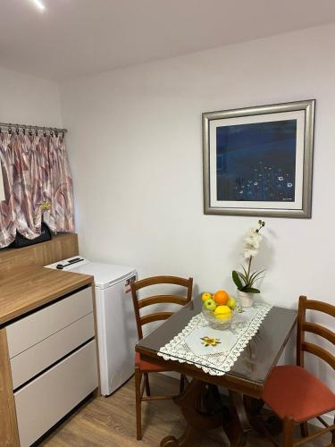 a small kitchen with a table with a bowl of fruit on it at Studio Apartment in Split in Split