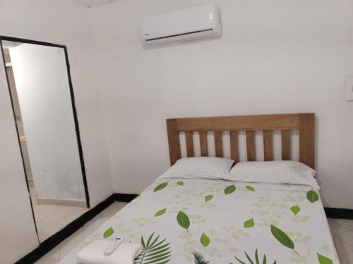 a bedroom with a bed and a air conditioner at Mary playas coveñas in Coveñas
