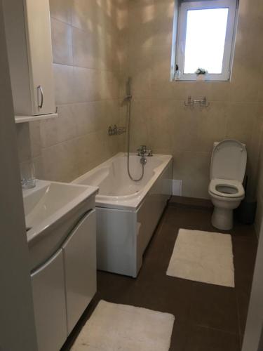 a bathroom with a tub and a toilet and a sink at Duplex in Chişinău