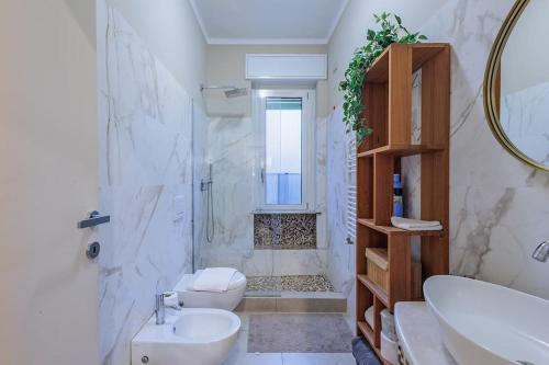 a bathroom with a sink and a toilet and a shower at Stylish and Perfect Place for Families and Friends in Milan