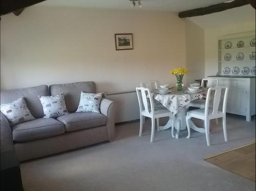 a living room with a couch and a table and chairs at Fell View Bassenthwaite in Bassenthwaite