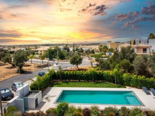 a swimming pool in a yard with a parking lot at Mamma Mia House by Stay ici in Pêra