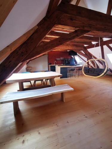 a large room with two picnic tables in a attic at Kníže Ferdinand Apartments in Mikulov