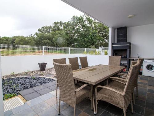 a wooden table and chairs on a patio at Mamma Mia House by Stay ici in Pêra