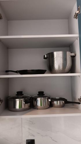 a shelf with pots and pans in a kitchen at B2 Urban Studio in Larisa