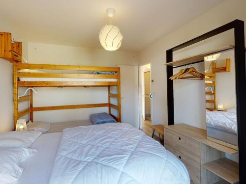 a bedroom with two bunk beds and a large bed at Villa confortable avec piscine, proche plage, 3 chambres, grand séjour, patio, WIFI, équipement complet - FR-1-413-87 in Capbreton