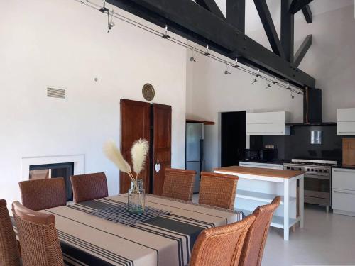 une cuisine et une salle à manger avec une table et des chaises dans l'établissement Maison idéale à Mendionde pour 8 personnes, avec grand jardin et équipements modernes - FR-1-495-104, à Mendionde