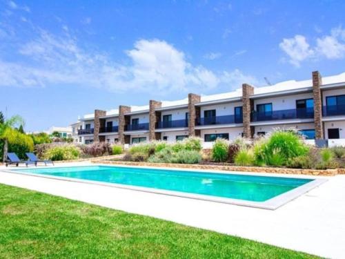 an exterior view of a building with a swimming pool at Mamma Mia House by Stay ici in Pêra