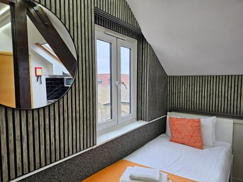 a small room with a window and a white couch at London Stay Apartments in London