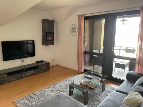 a living room with a couch and a tv at City View in Bodenwerder