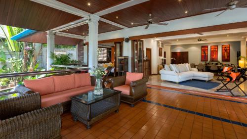 a large living room with couches and chairs at Talay Naiharn Villa in Rawai Beach