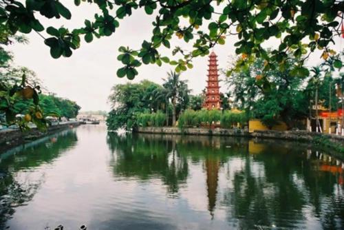 a view of a river with a pagoda in the background at Giảm Giá 25 Phần Trăm- Homestay - Kim Mã - Giang Văn Minh in Hanoi