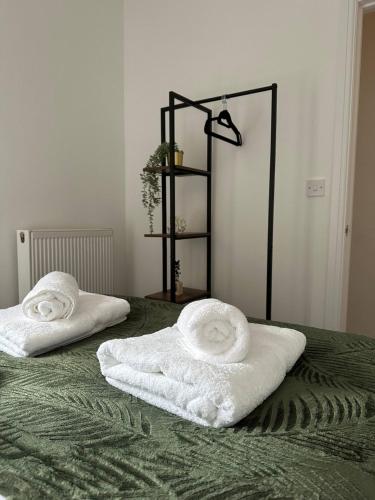 two towels are sitting on top of a bed at No 1 Seafield - sleeps 5 - Lincoln City in Lincolnshire