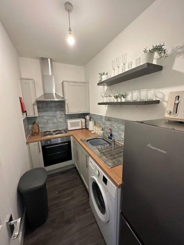 a kitchen with a sink and a dishwasher at No 1 Seafield - sleeps 5 - Lincoln City in Lincolnshire