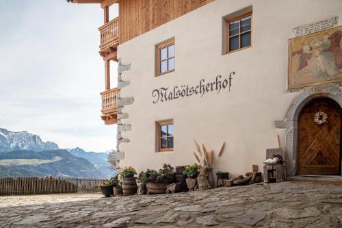 a building with a sign on the side of it at Malsötscherhof Apt C in Villandro