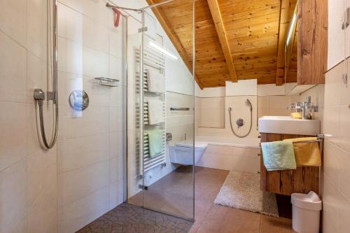 a bathroom with a shower and a sink and a toilet at Malsötscherhof Apt C in Villandro