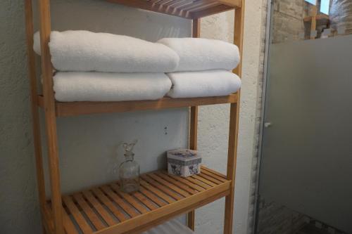 a stack of towels on a shelf in a bathroom at Hermosas suites en Hacienda Kuxtal in Palmillas