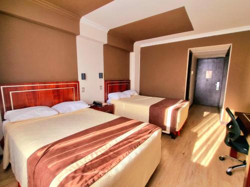 Ein Bett oder Betten in einem Zimmer der Unterkunft Hotel El Araucano