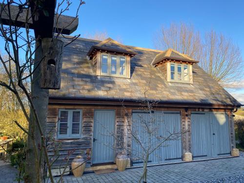 a house with blue doors and windows on it at Fabulous Barn in Great Wolford Moreton in Marsh in Shipston on Stour