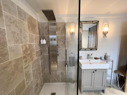 a bathroom with a shower and a sink at Luxurious Oak Barn in Cotswold Countryside in Shipston-on-Stour