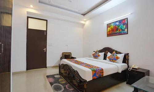 a bedroom with a bed in a room at FabHotel Noida Sector 50 in Noida