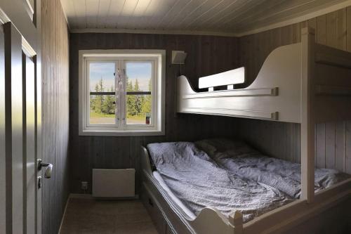 a bedroom with a bunk bed and a window at Modern cottage at Nordseter/Sjusjøen/Lillehammer in Lillehammer